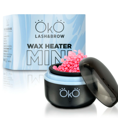 Aquecedor de cera preto com pellets rosa e caixa azul clara com texto