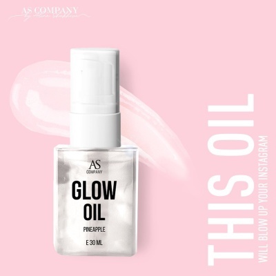 Frasco de Glow Oil aroma ananás sobre fundo rosa com texto publicitário