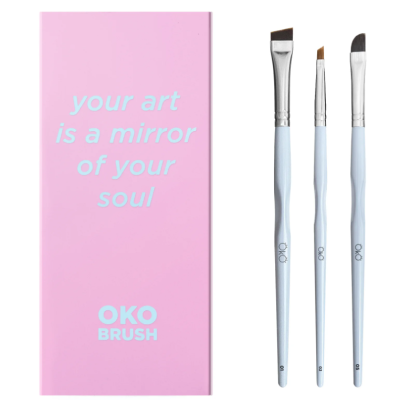 Caixa rosa com frase inspiradora e três pincéis com cabo branco