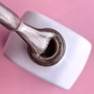 Frasco branco de verniz metálico prateado aberto com pincel aplicador