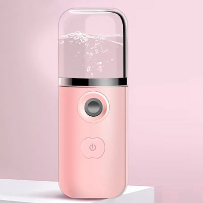 Nebulizador portátil rosa com compartimento transparente e botão de ligar