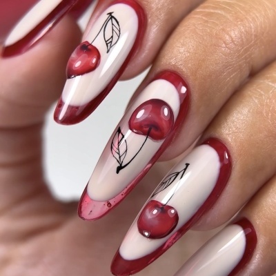 Unhas artificiais creme com borda vermelha e desenhos de cerejas