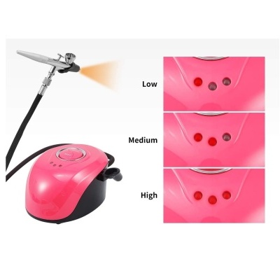 Sistema de aerografia elétrico cor-de-rosa com base preta e três LEDs indicadores