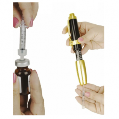 Syringes being used to draw and apply liquid from a brown glass vial.