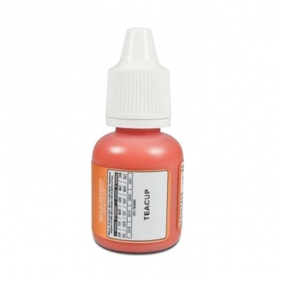 Frasco pequeno coral com tampa branca e etiqueta TEACUP