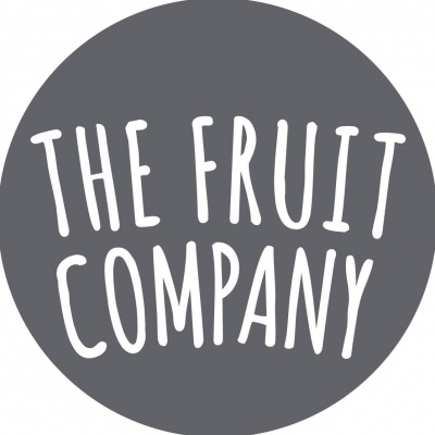 Logótipo circular cinza com texto branco 'THE FRUIT COMPANY'