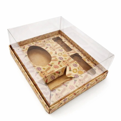 Caixa de papel cartão com tampa transparente decorada com coelhos e ovos da Páscoa