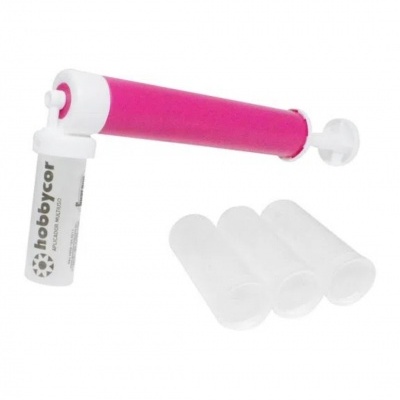 bomba manual rosa com cápsulas transparentes ao lado