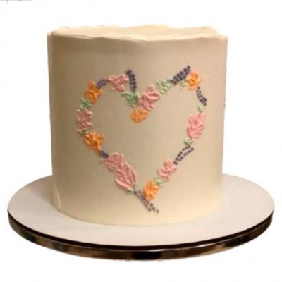 Bolo redondo branco com coração de flores coloridas