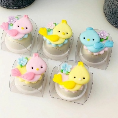 Artigos decorativos de passarinho em açúcar colorido com flores lilases