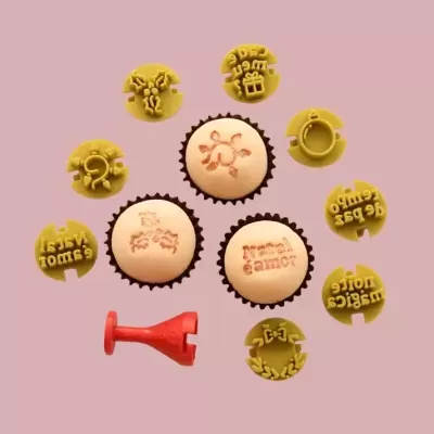 Carimbos amarelos e cupcakes com carimbos em creme sobre fundo rosa