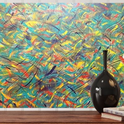 Quadro abstrato colorido sobre móvel com castiçal, vaso preto, livros e lâmpada