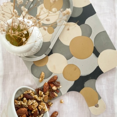 Tábuas de corte coloridas com frutos secos e vaso com flores secas