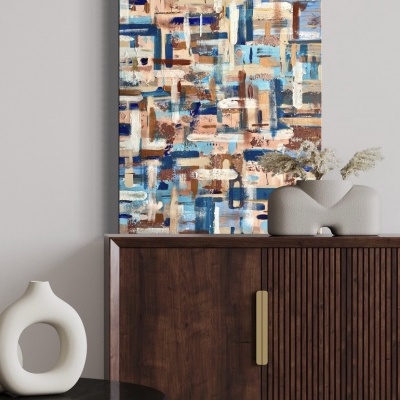 Quadro abstrato colorido pendurado acima de cómoda com vaso e mesa redonda preta