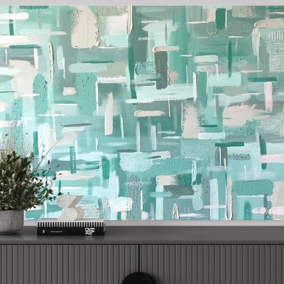 Quadro abstrato verde sobre móvel cinza com vaso e livro