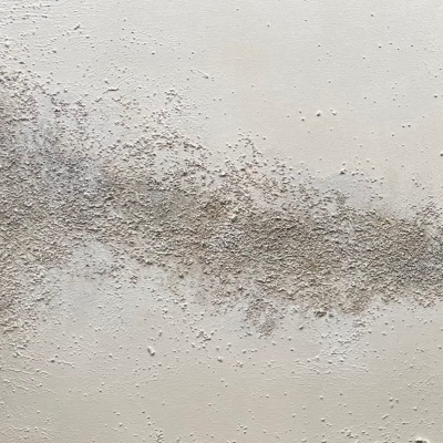 Superfície branca com manchas cinza e bege dispersas em pó