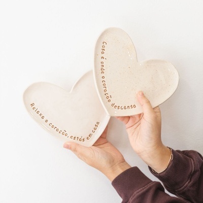 Dois pratos de cerâmica em forma de coração com texto em português.