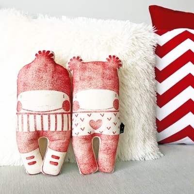 Bonecos de tecido vermelho e branco com almofadas branca felpuda e vermelha com zig zag