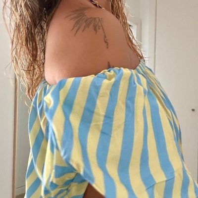 Top feminino às riscas amarelas e azuis com mangas elásticas curtas.