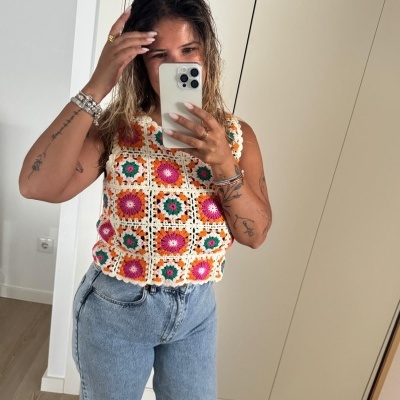 Top de malha crochet colorido com padrão em quadrados e jeans azul claro