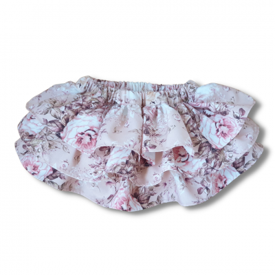 saia curta de bebé com padrão floral rosa e lilás