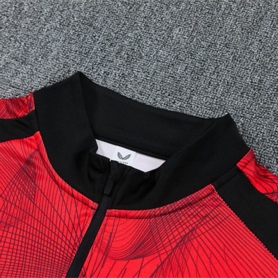 Camisola desportiva vermelha com padrão geométrico e gola preta com fecho