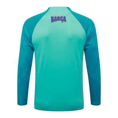 Camisola desportiva de manga comprida azul e turquesa com texto BARÇA nas costas
