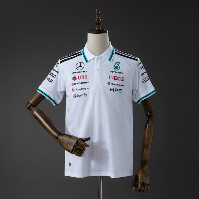 Polo branco com múltiplos logótipos e detalhes em verde e preto