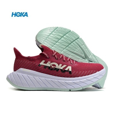 Ténis de corrida HOKA em tecido vermelho com sola verde clara e entressola branca.