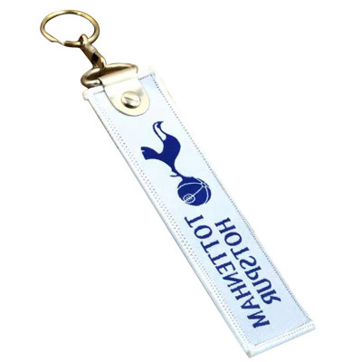 Chaveiro branco com texto azul Tottenham Hotspur e logo do clube de futebol