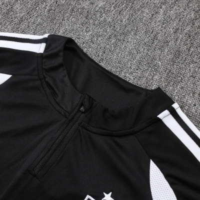 Camisola desportiva preta com fecho e detalhes brancos sobre fundo cinzento
