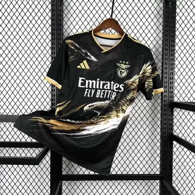 Camisola de futebol preta e dourada com logótipos e design de águia