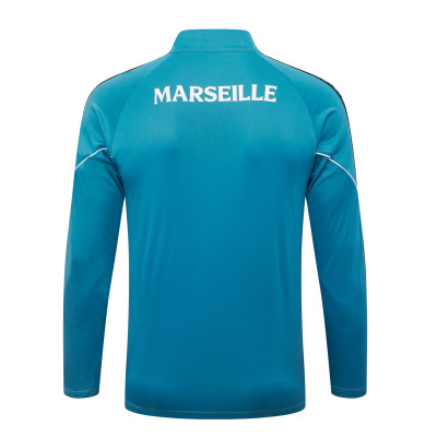 Casaco desportivo azul turquesa com palavra MARSEILLE nas costas