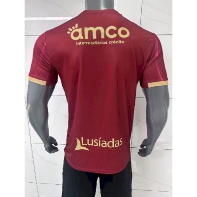 Camisola bordô de desporto com textos amarelos nas costas em manequim cinza
