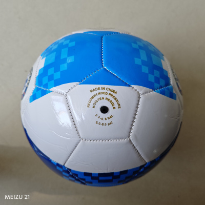 Bola de futebol branca e azul com texto e padrões geométricos.