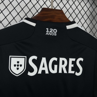 Detalhe da parte de trás de uma t-shirt preta com logótipo branco SAGRES e texto 120 ANOS
