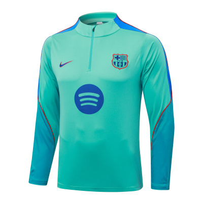 Sweatshirt desportiva turquesa com símbolo do FC Barcelona e logos da Nike e Spotify
