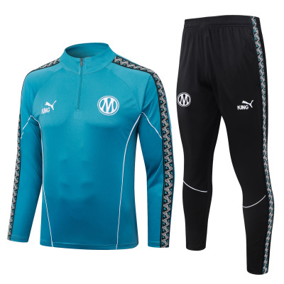Conjunto desportivo azul turquesa e preto com logos PUMA e KING.