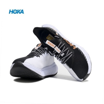 Sapatilhas desportivas HOKA em branco e preto com sola espessa e logo azul