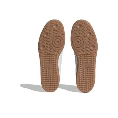 Sola de sapatilhas Adidas castanhas com padrão circular e triangular