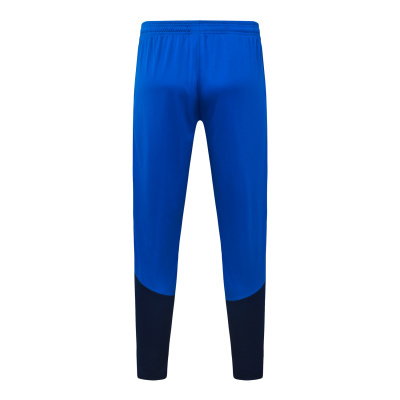 Calças desportivas azuis com parte inferior azul escuro e cintura elástica.