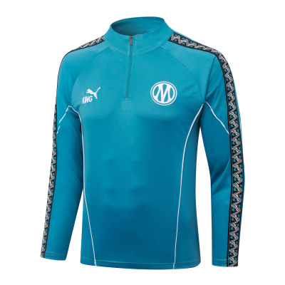 Sweatshirt desportiva azul turquesa com fecho curto na gola e franjas com padrão gráfico.