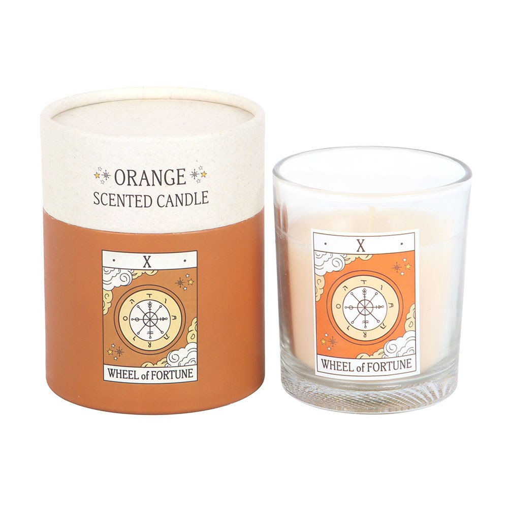 Conjunto de vela perfumada de laranja com embalagem em papel e copo de vidro.