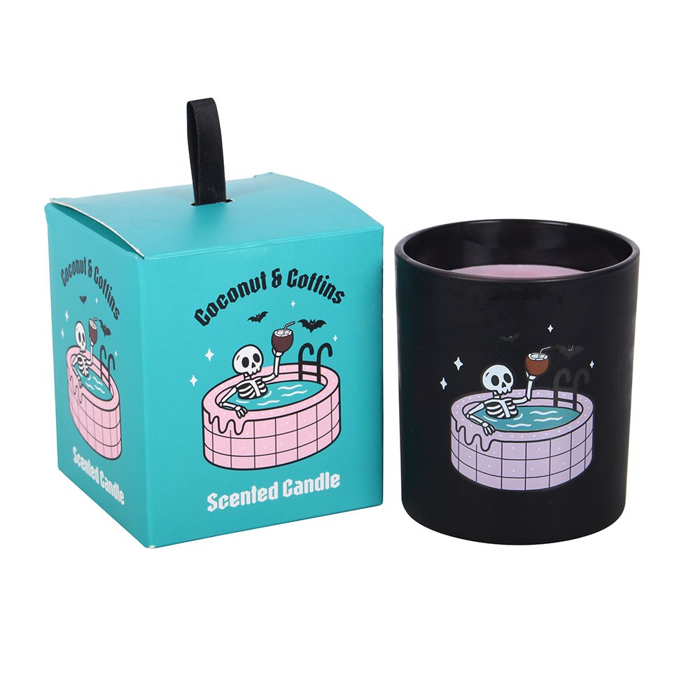Vela perfumada com esqueleto numa piscina em copo preto e caixa azul