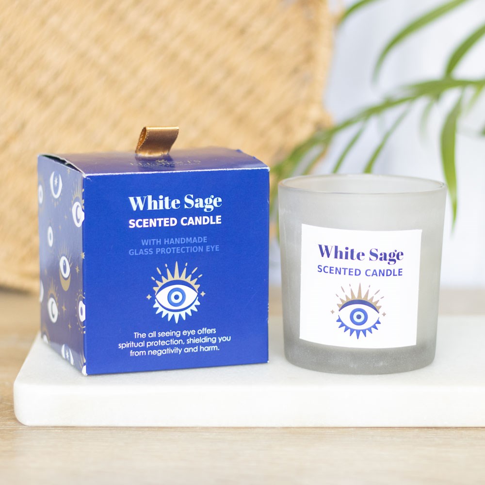 Vela perfumada White Sage com embalagem azul e ilustração de olho protetor.