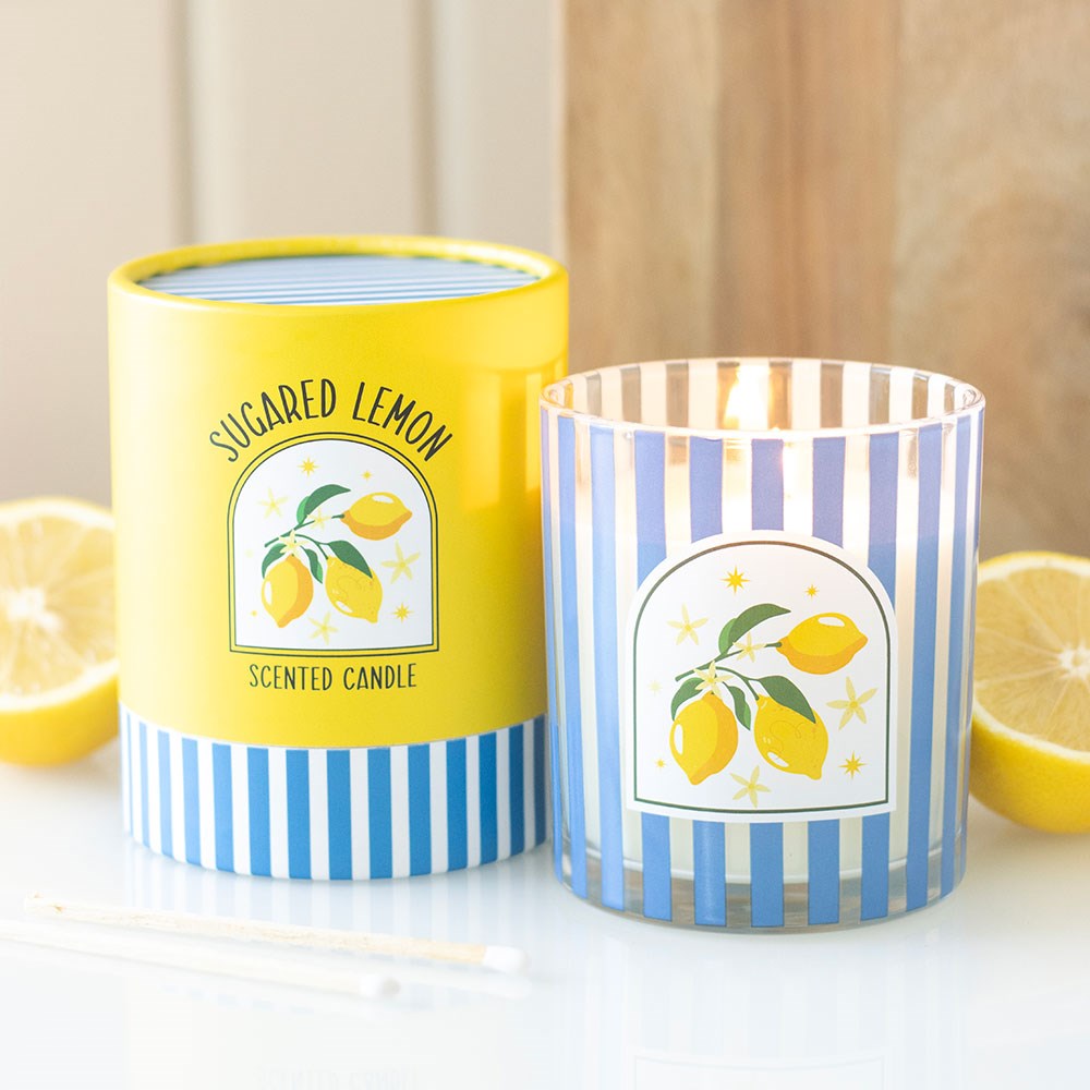 Vela perfumada Sugared Lemon em copo de vidro com riscas azuis e brancas e embalagem amarela com limões decorativos