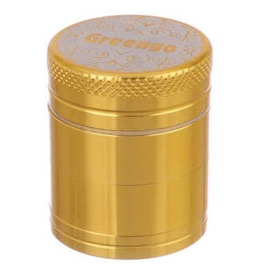 Recipiente metálico dourado com tampa decorada e a palavra Greemo