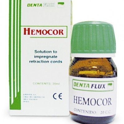Frasco pequeno de vidro castanho com tampa verde e embalagem branca e verde do produto DENTA FLUX HEMOCOR