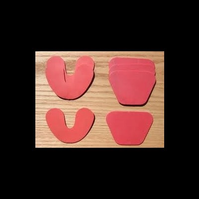 Protetores de silicone vermelhos em formatos U e trapezoidais sobre madeira clara