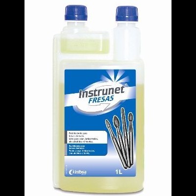 Frasco 1L de líquido Instrunet Fresas com rótulo azul e branco e fresas dentárias